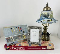 Group shot of lamp, golf frame, tee set and Scrabble game showing overall condition