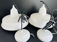 Top view of both pendant lights showing shades, cords, and ceiling canopies