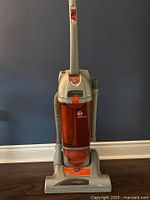 Front view of Hoover upright bagless vacuum showing dust canister and base