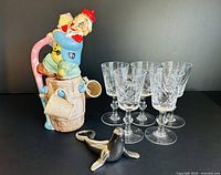 front view of clown decanter, five crystal glasses, seal opener