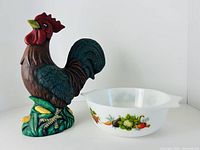 Casserole dish and ceramic rooster side by side