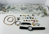 All items laid out with royal scarf; shows overall lot including jewellery and watches
