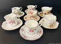 All seven teacup and saucer sets grouped together