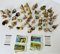 Full lot showing figurines arranged with cards below