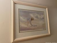 Front view of framed print on wall