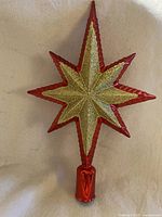 Front view of red and gold star tree topper