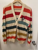 Full front view of the striped cardigan on hanger