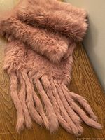 Full view of scarf draped showing fur texture and tassels