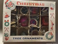 Front of original box showing 12 ornaments in compartments