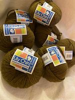 Six labeled skeins of Lily Chin Park Avenue yarn displayed together