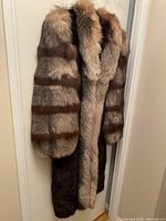 Full view of coat front showcasing mink body and fox-trimmed sleeves