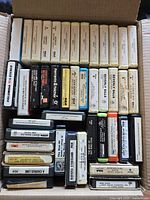 Top view of full box showing rows of 8-track tapes