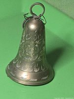 Full view of brass hand bell showing size and etched design