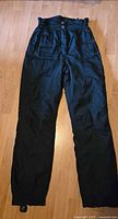 Full view of front of black Coltech insulated snow pants