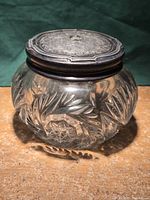 Overall view of crystal bowl with ornate metal lid