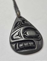 front view teardrop pendant showing Indigenous carving