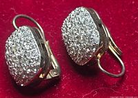 Both earrings showing pavé stone fronts on red background