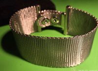 Angled view of full bracelet showing mesh construction and clasp