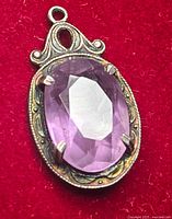 Front view of sterling pendant with purple gemstone