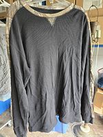 Front view of black thermal shirt with camo accents