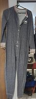 Full view of grey union suit hanging