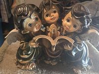 Front view of three baby angels figurine