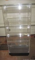 Front view of clear acrylic display case showing overall form and base