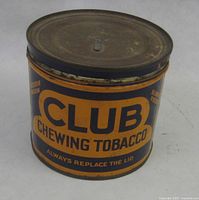 Front view showing Club Chewing Tobacco branding and rusted lid