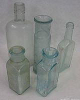 Group shot of all five aqua glass bottles front view