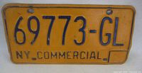 Front view of license plate showing number, color, and mounting holes