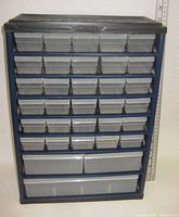 Front view showing 30 small drawers and 2 large drawers in blue metal frame