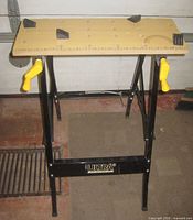 Full view of folding Ultra Steel workbench standing
