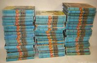 Three tall stacks of Hardy Boys blue-spine hardcover books
