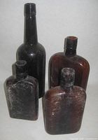 Group shot of four brown glass bottles