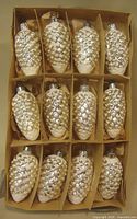 Box of 12 silver and white pine cone glass ornaments in divider box
