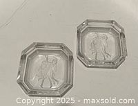 Two clear octagonal intaglio glass salt cellars displayed together
