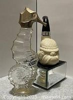 Seahorse and bulldog pipe bottles front view