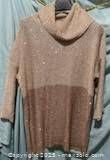 Full front view of gold sequin sweater on hanger