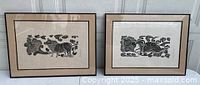Both framed woodblock prints side by side