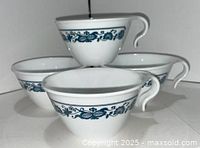 Four Corelle Old Town Blue hook-handle cups stacked