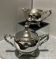 Creamer and lidded sugar bowl front view