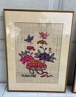 Close view of first framed embroidered floral piece