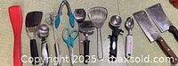 All fourteen kitchen tools laid out on surface