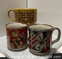 Front view of three mugs showing exterior patterns