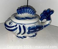 Side view of blue and white fish-shaped lidded dish