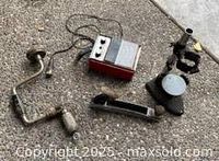 All four items laid out: brace drill, hand plane, pipe vise, electrical analyzer