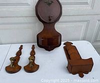 All four wooden wall pieces grouped on table