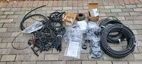 Entire lot laid out: tubing coils, fittings, stakes, boxes, bags