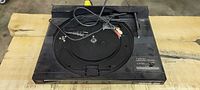 Top view of Fisher MT-728 turntable showing platter, tonearm mechanism, attached cables, missing dust cover