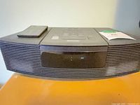 Front view of Bose Wave Radio/CD with remote on top